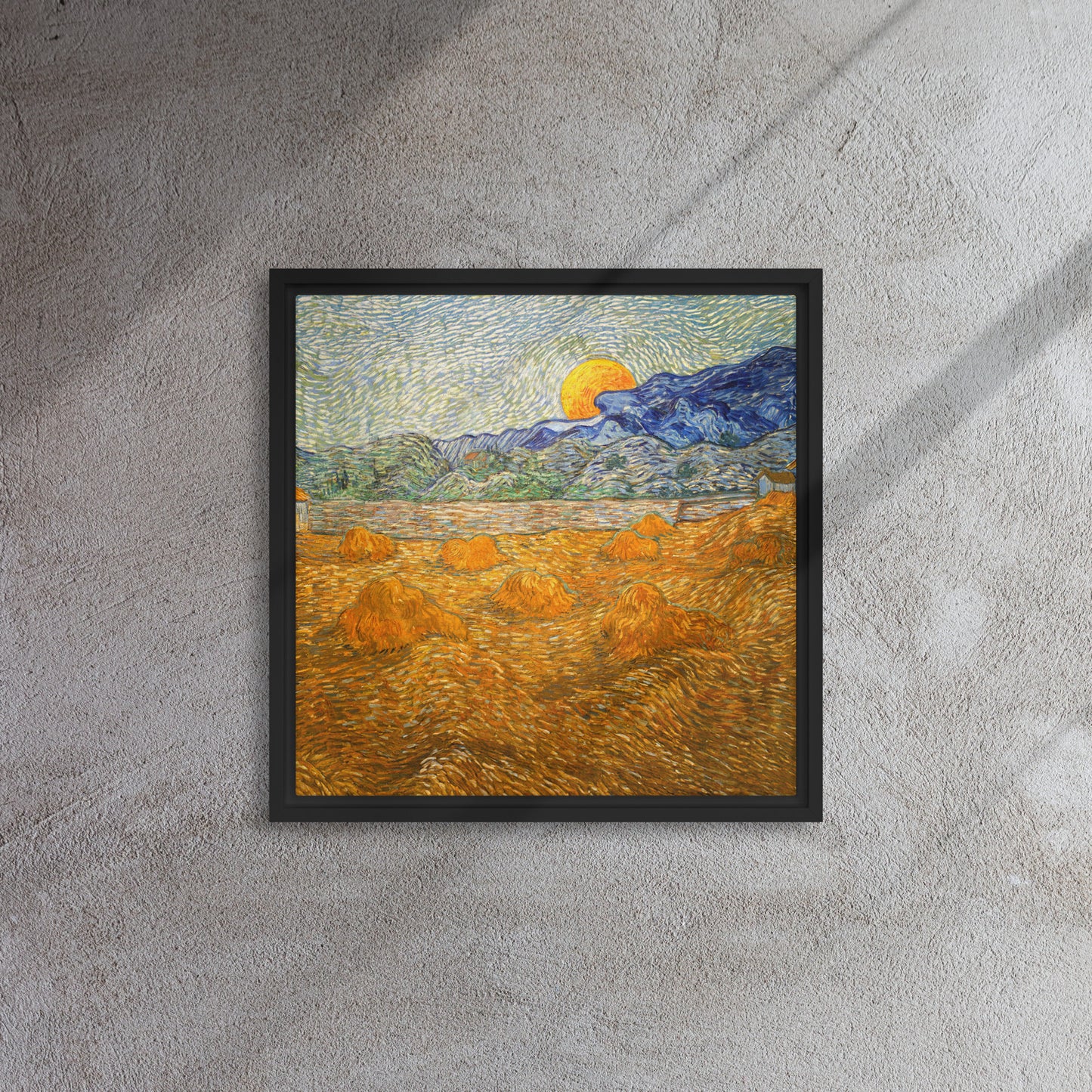 Van Gogh's 'Landscape with Wheat Sheaves and Rising Moon' on a 16"x16" black framed canvas print on a textured gray wall.