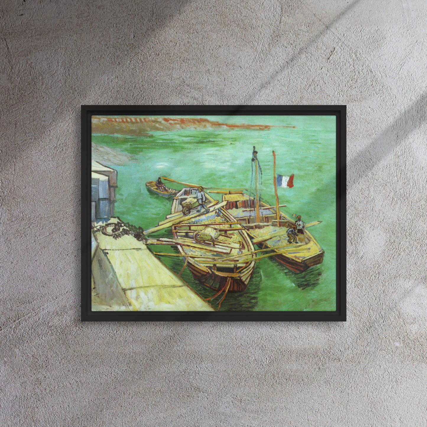 Van Gogh's 'Quay with Men Unloading Sand Barges' on a 16"x20" black framed canvas print on a textured gray wall.