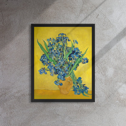 Van Gogh's 'Vase with Irises Against a Yellow Background' on a 16"x20" black framed canvas print on a textured gray wall.