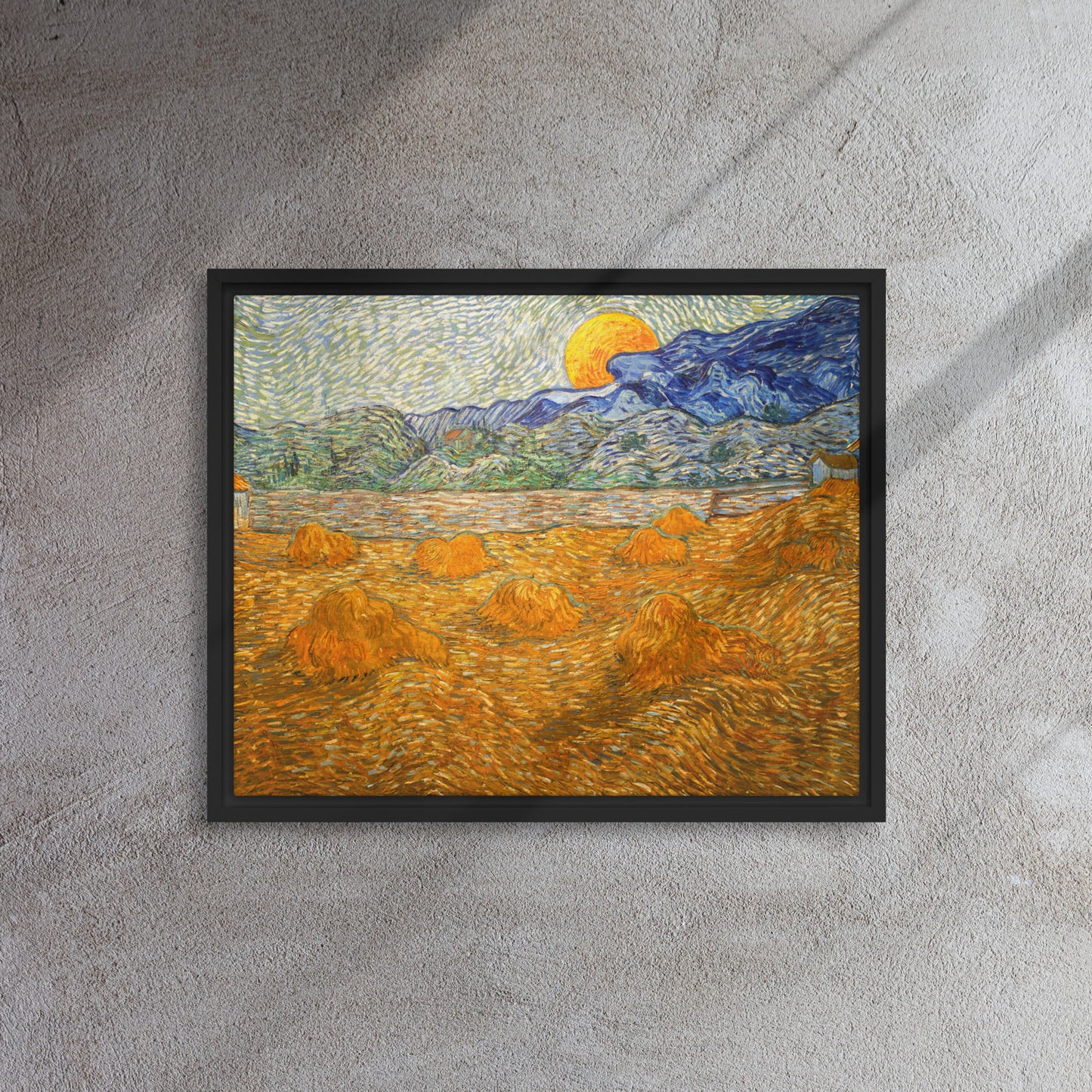 Van Gogh's 'Landscape with Wheat Sheaves and Rising Moon' on a 16"x20" black framed canvas print on a textured gray wall.