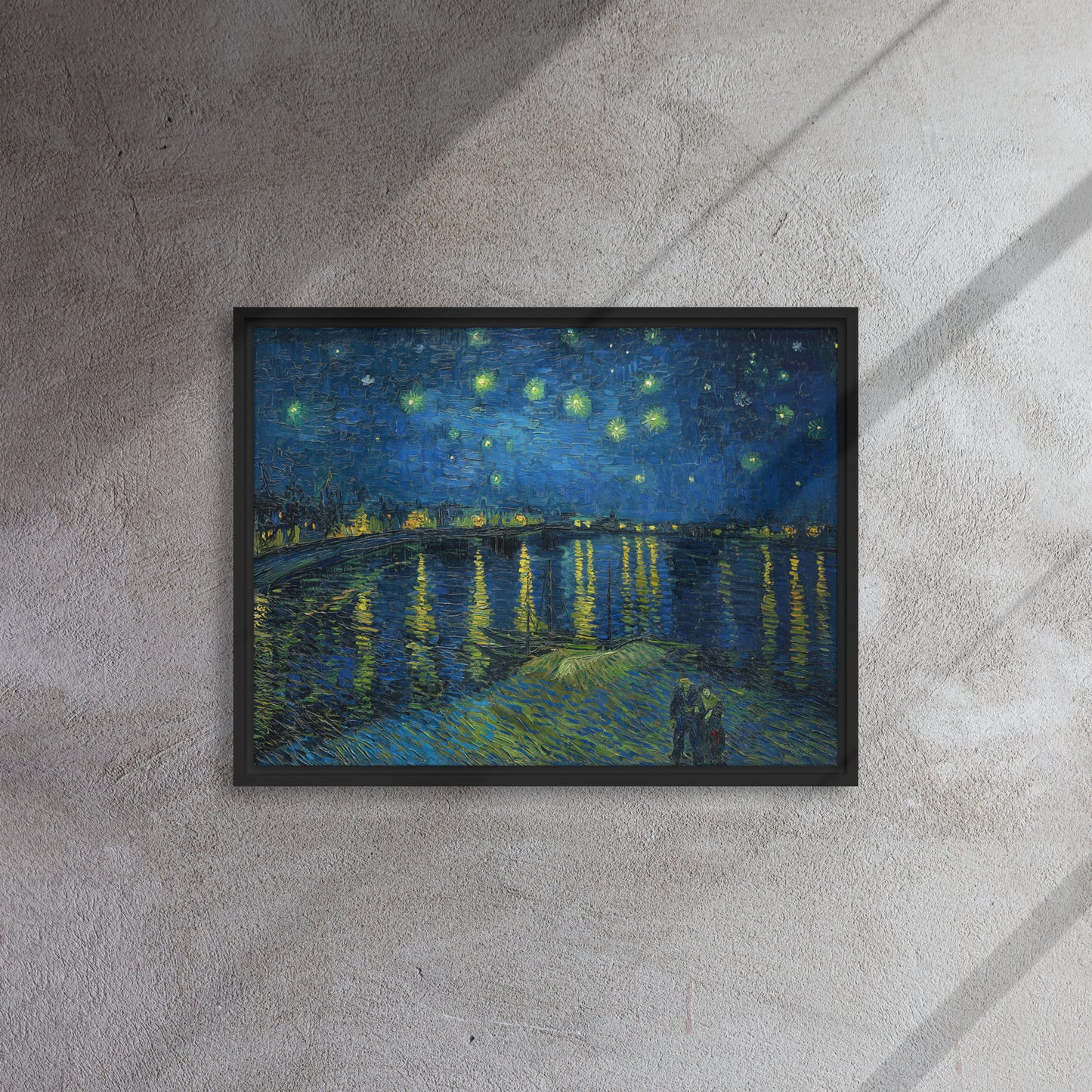 Van Gogh's 'Starry Night Over the Rhone' on a 18"x24" black framed canvas print on a textured gray wall.