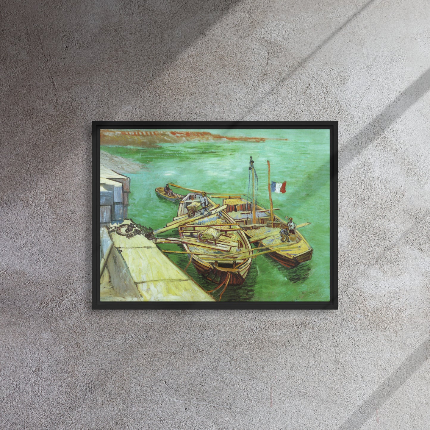 Van Gogh's 'Quay with Men Unloading Sand Barges' on a 18"x24" black framed canvas print on a textured gray wall.