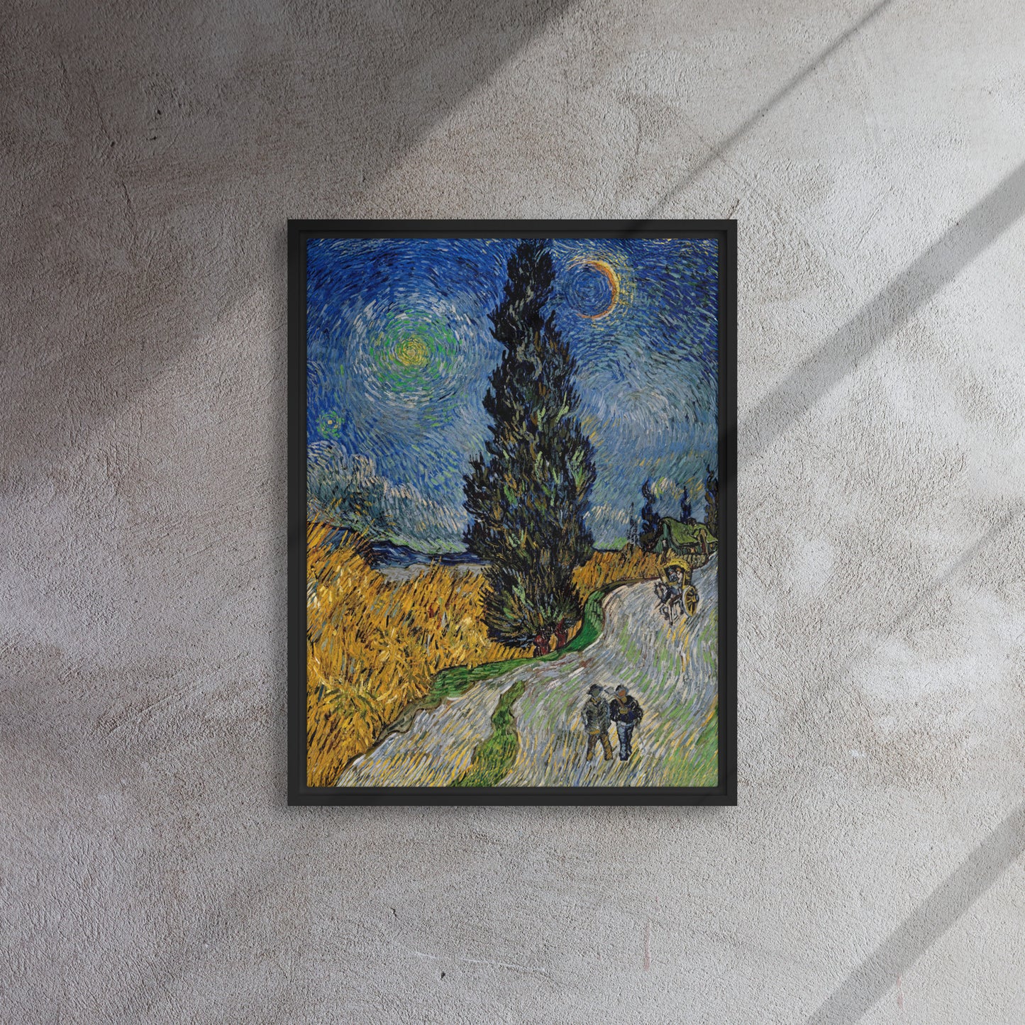 Van Gogh's 'Road with Cypress and Star' on a 18"x24" black framed canvas print on a textured gray wall.