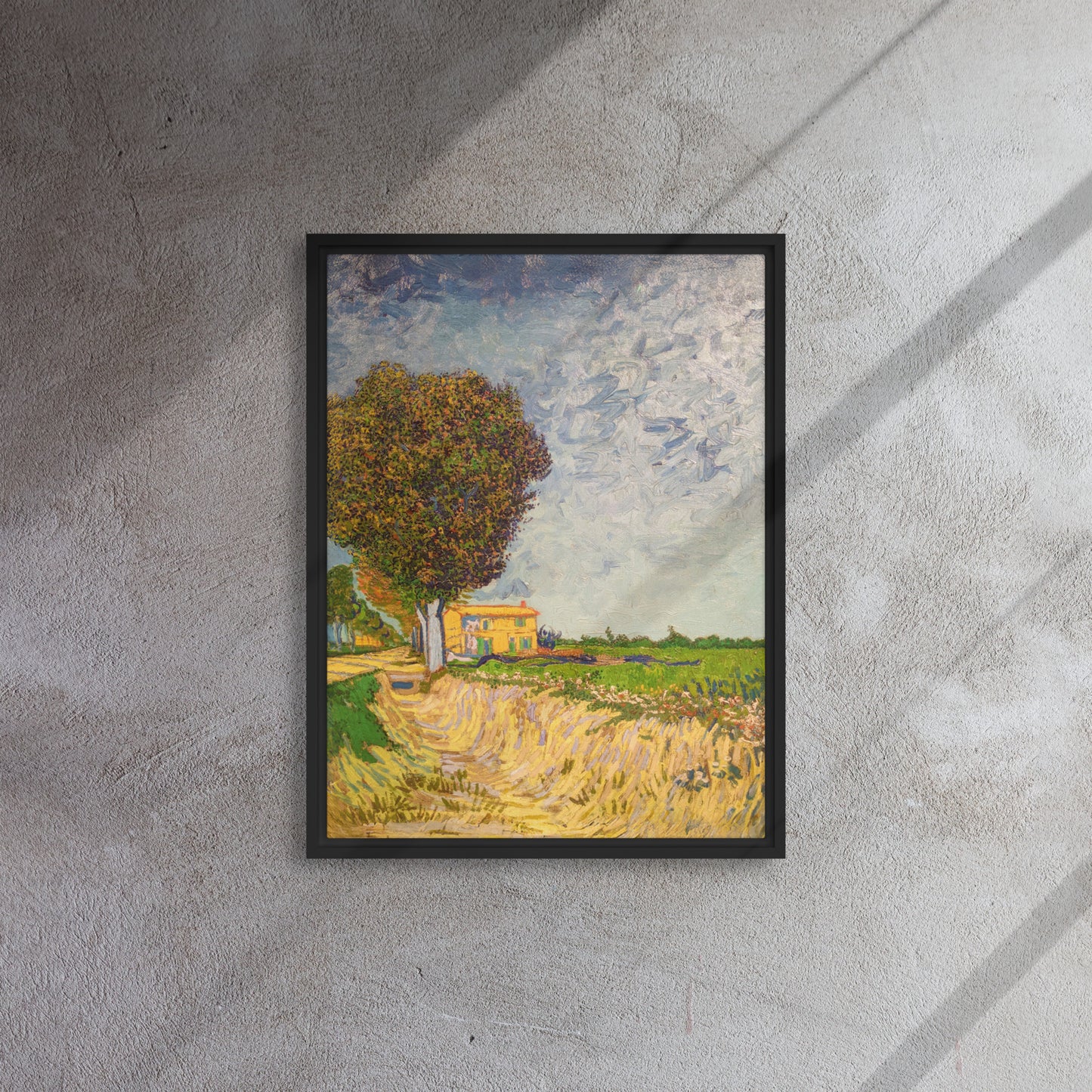 Van Gogh's 'A Lane near Arles' on a 18"x24" black framed canvas print on a textured gray wall.
