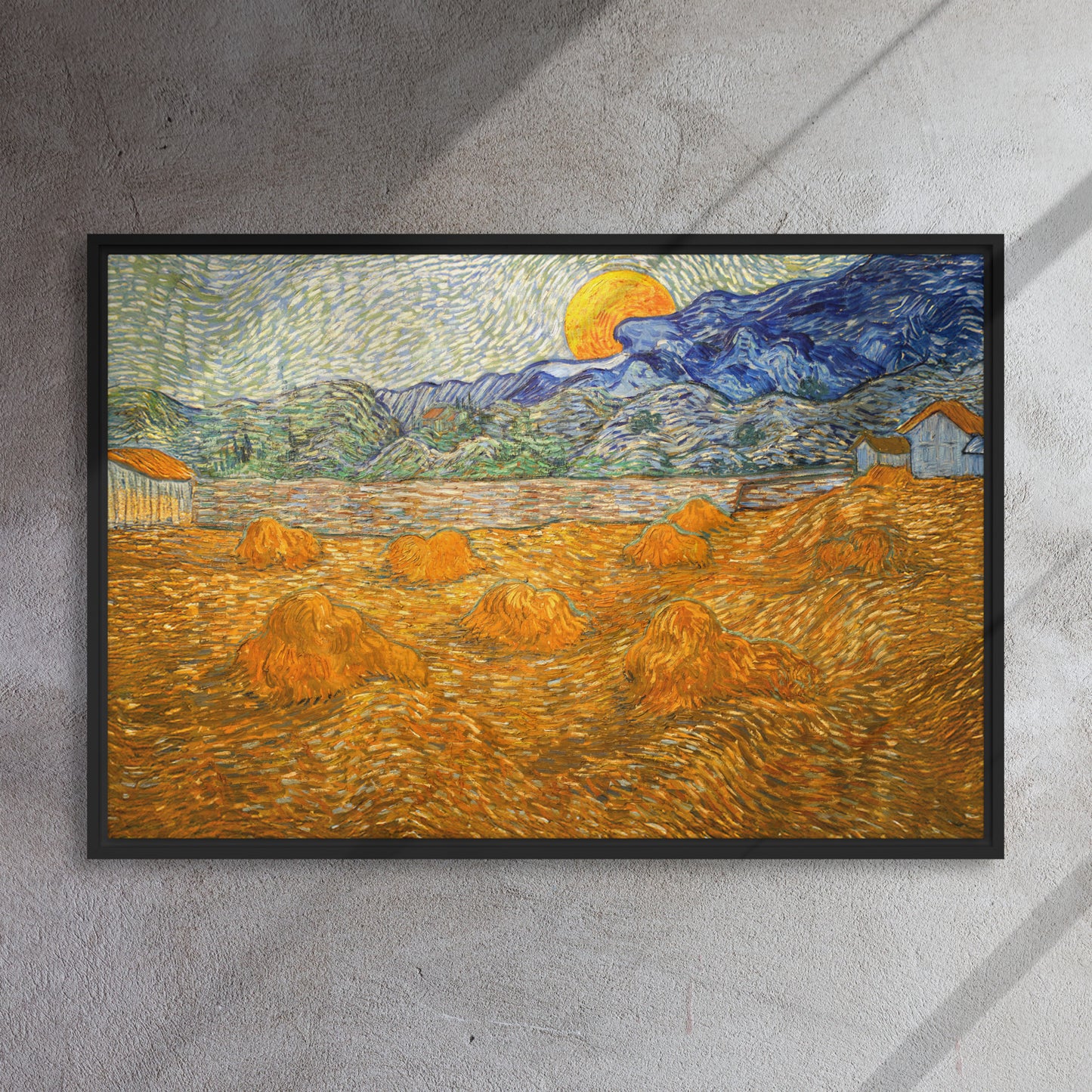 Van Gogh's 'Landscape with Wheat Sheaves and Rising Moon' on a 24"x36" black framed canvas print on a textured gray wall.
