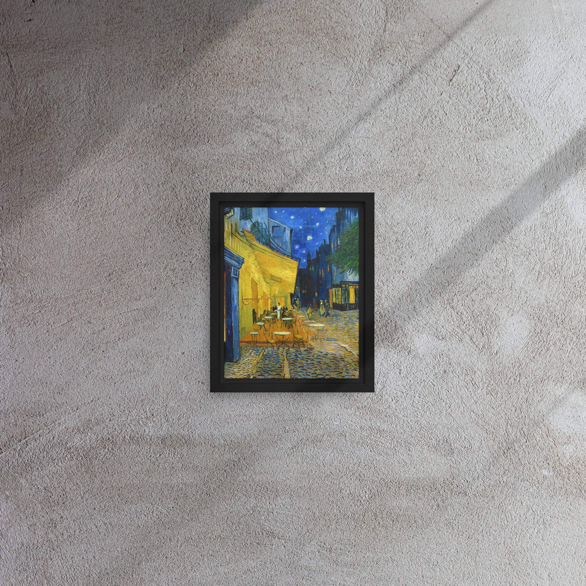 Van Gogh's 'Café Terrace at Night' on a 8"x10" black framed canvas print on a textured gray wall.