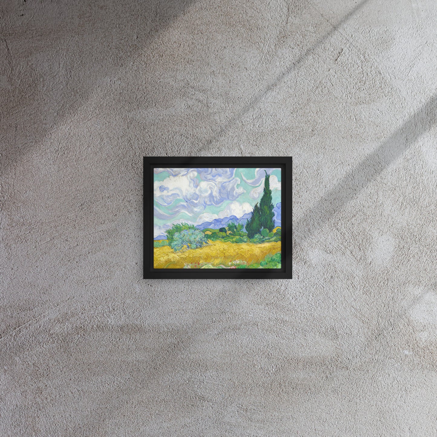 Van Gogh's 'Wheat Field with Cypresses' on a 8"x10" black framed canvas print on a textured gray wall.