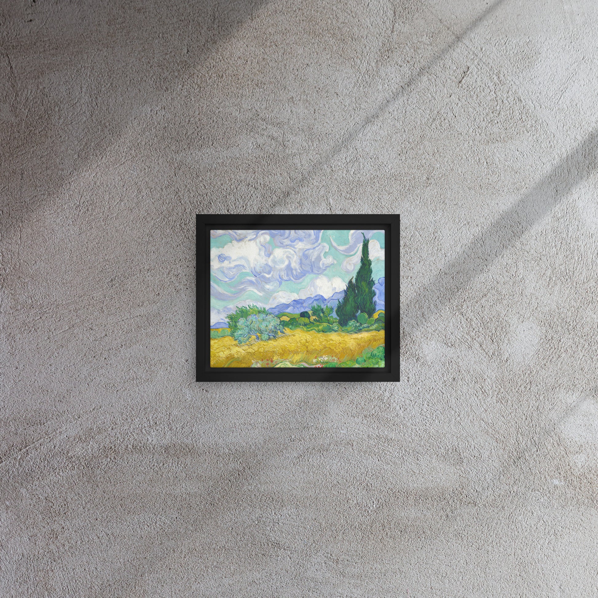 Van Gogh's 'Wheat Field with Cypresses' on a 8"x10" black framed canvas print on a textured gray wall.