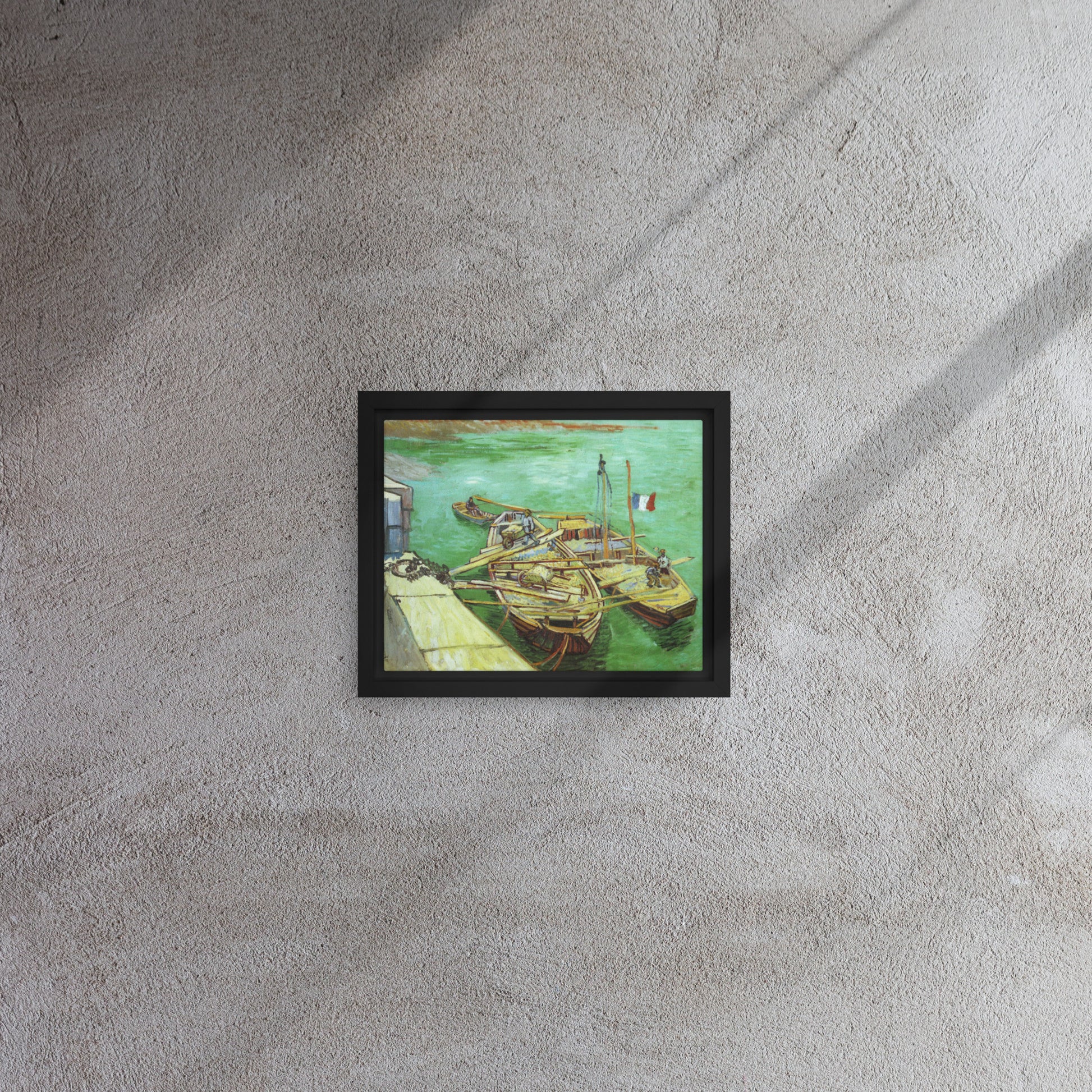 Van Gogh's 'Quay with Men Unloading Sand Barges' on a 8"x10" black framed canvas print on a textured gray wall.