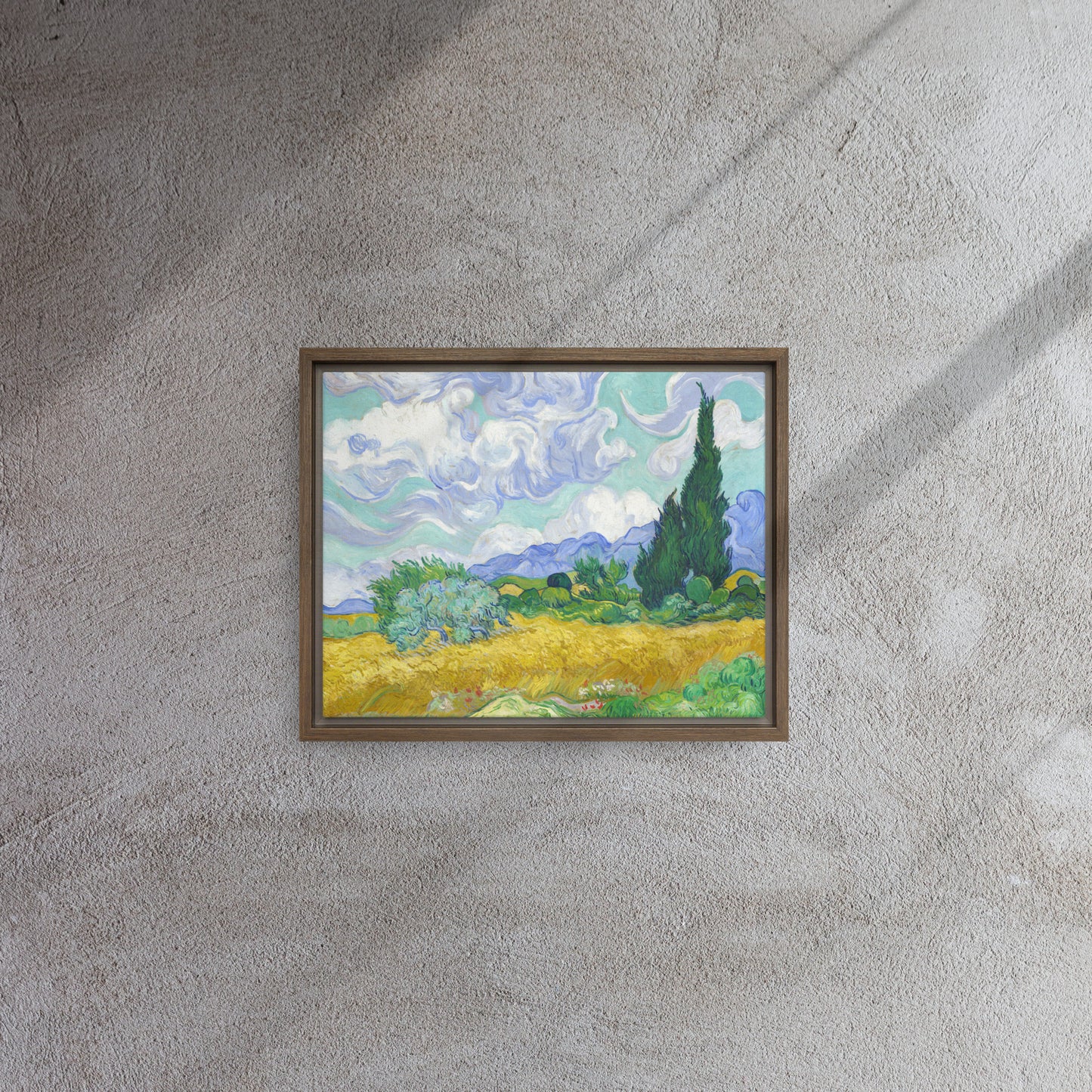 Van Gogh's 'Wheat Field with Cypresses' on a 11"x14" brown framed canvas print on a textured gray wall.