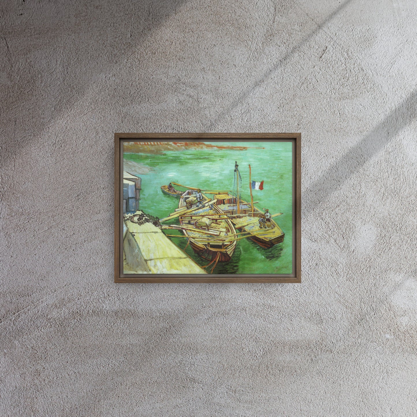 Van Gogh's 'Quay with Men Unloading Sand Barges' on a 11"x14" brown framed canvas print on a textured gray wall.