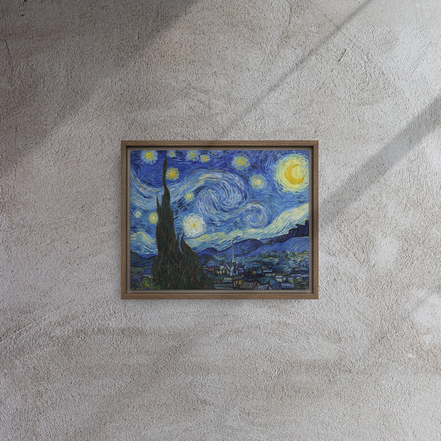 Van Gogh's 'Starry Night' on a 11"x14" brown framed canvas print on a textured gray wall.