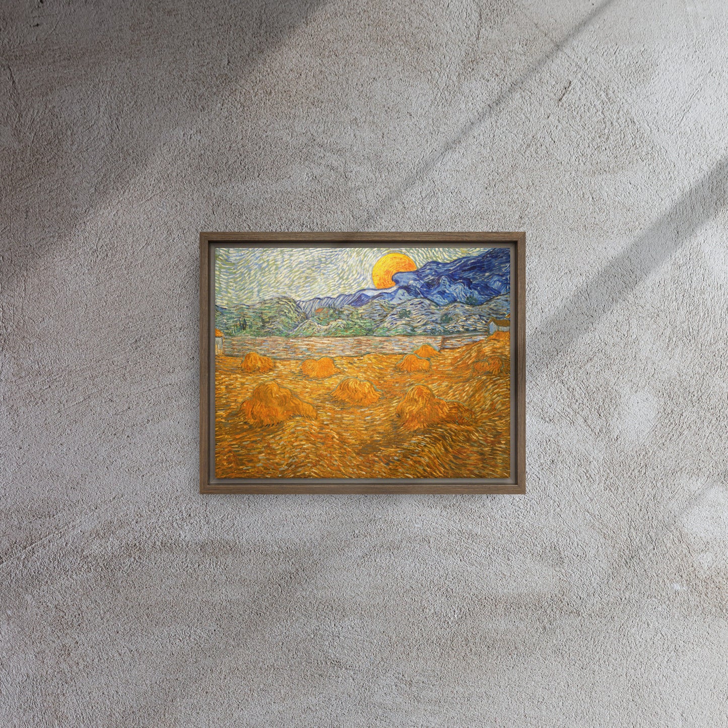 Van Gogh's 'Landscape with Wheat Sheaves and Rising Moon' on a 11"x14" brown framed canvas print on a textured gray wall.
