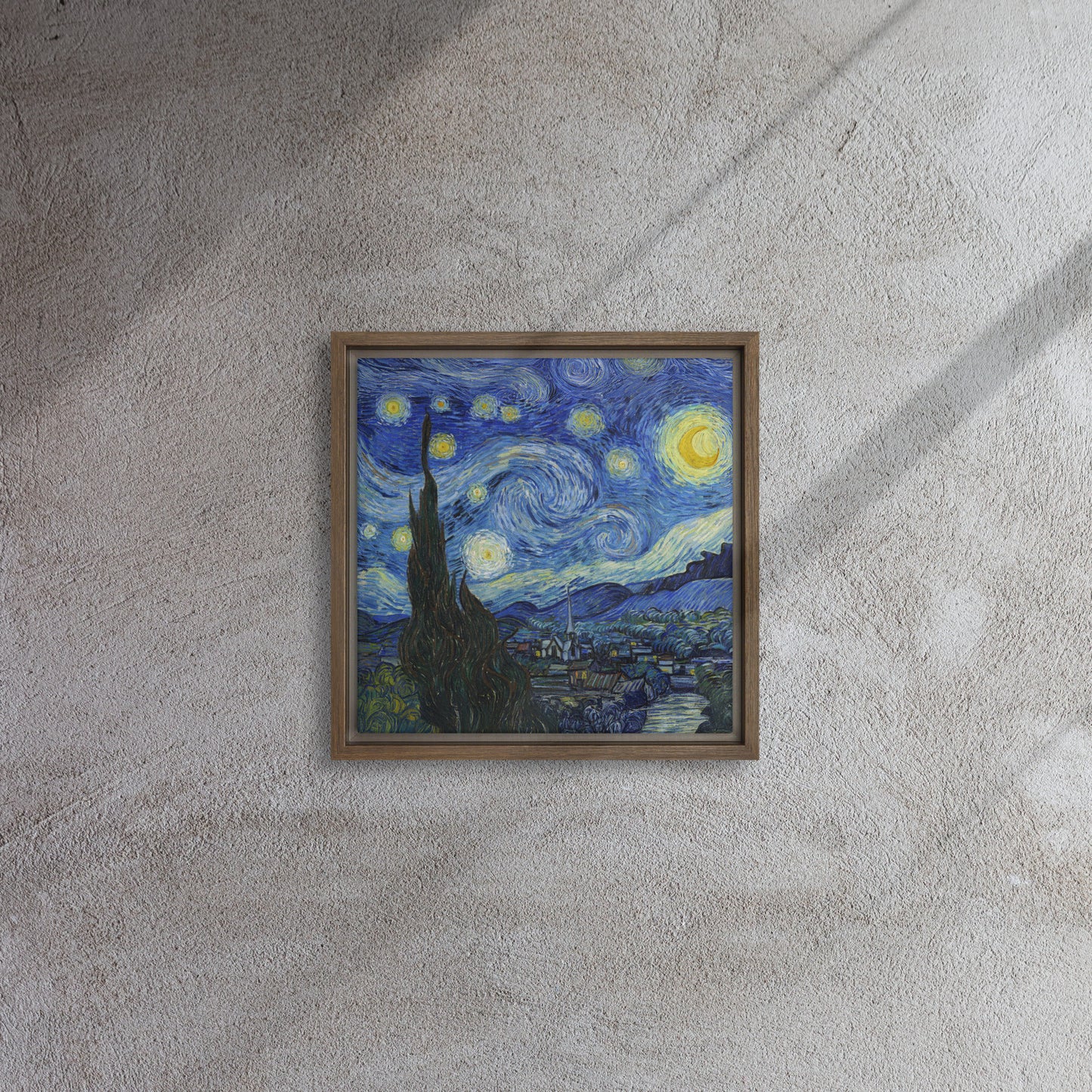 Van Gogh's 'Starry Night' on a 12"x12" brown framed canvas print on a textured gray wall.