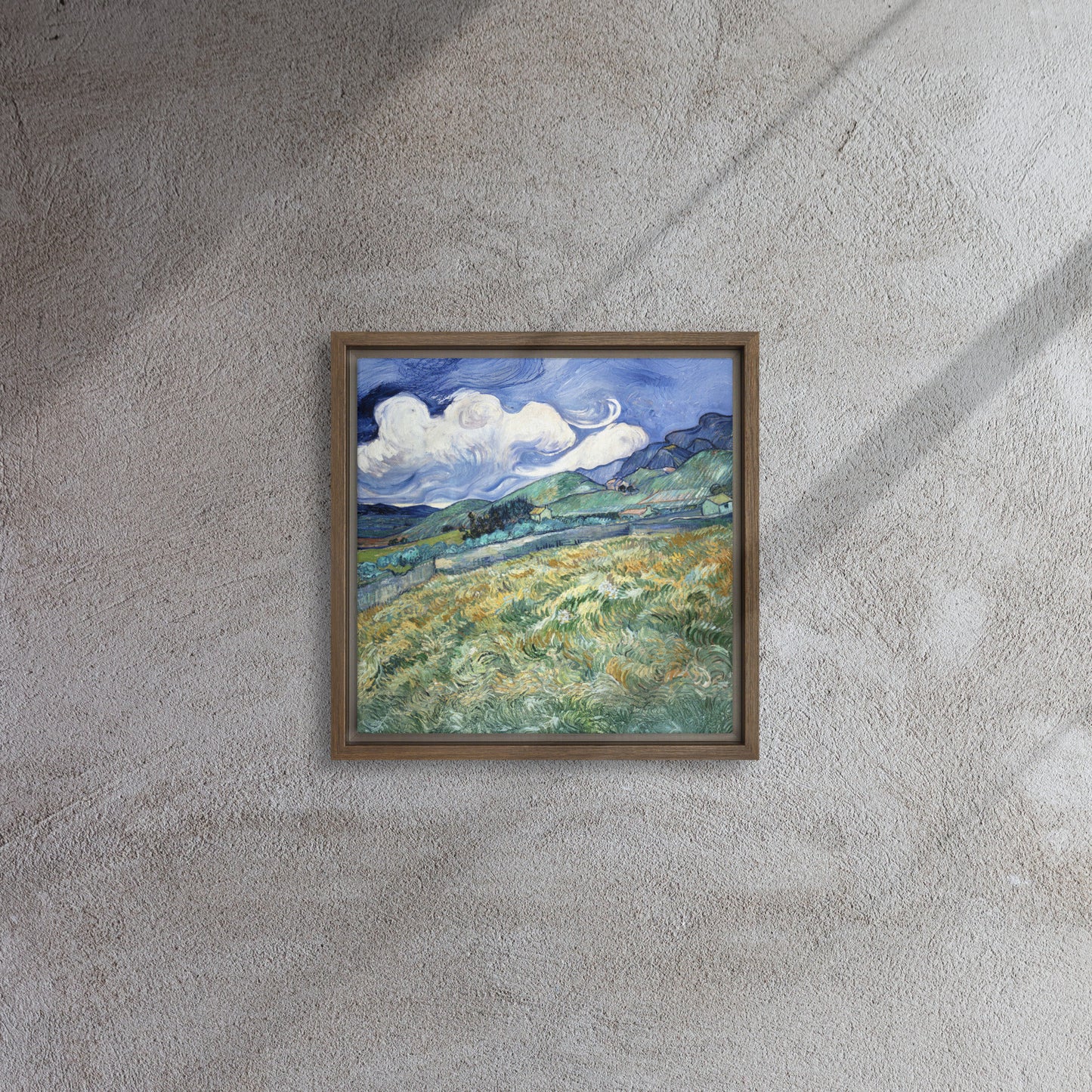 Van Gogh's 'Landscape from Saint-Rémy' on a 12"x12" brown framed canvas print on a textured gray wall.