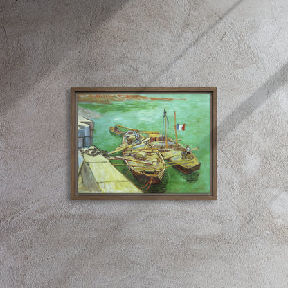 Van Gogh's 'Quay with Men Unloading Sand Barges' on a 12"x16" brown framed canvas print on a textured gray wall.