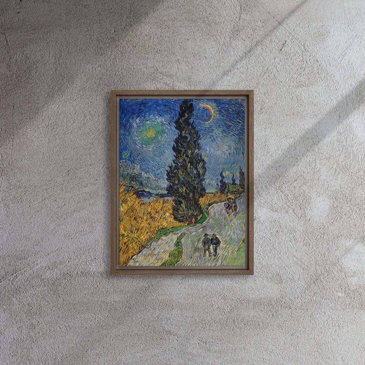 Van Gogh's 'Road with Cypress and Star' on a 12"x16" brown framed canvas print on a textured gray wall.
