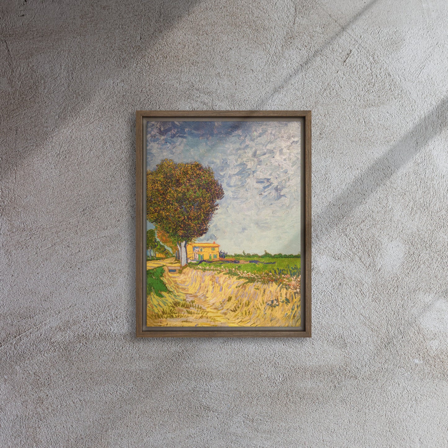 Van Gogh's 'A Lane near Arles' on a 12"x16" brown framed canvas print on a textured gray wall.