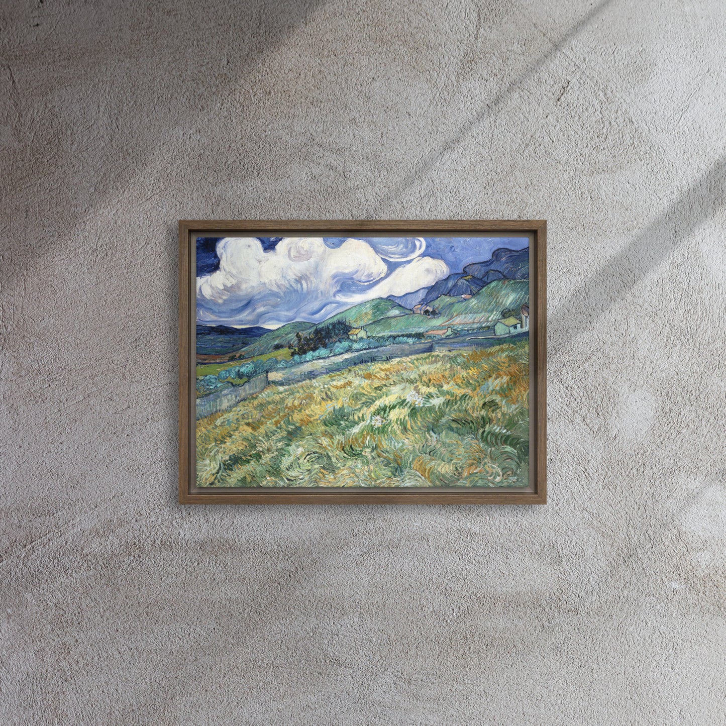 Van Gogh's 'Landscape from Saint-Rémy' on a 12"x16" brown framed canvas print on a textured gray wall.