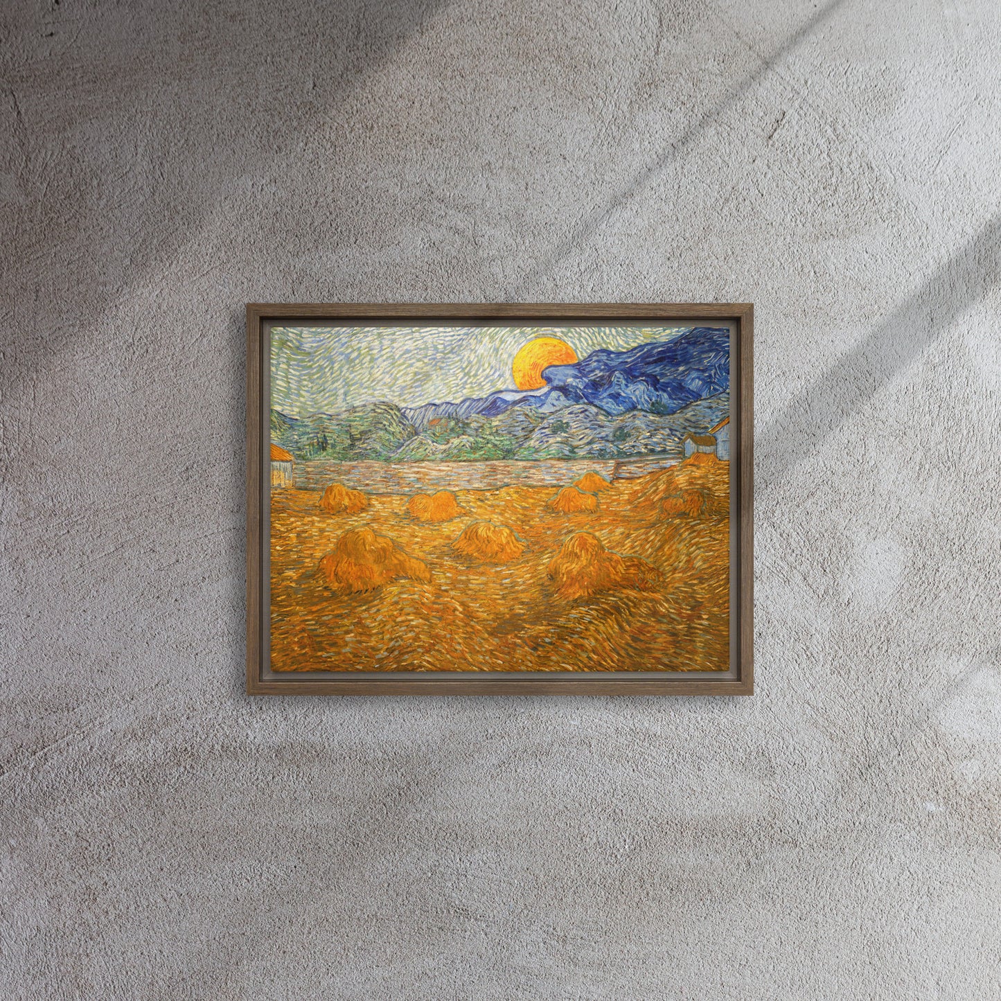 Van Gogh's 'Landscape with Wheat Sheaves and Rising Moon' on a 12"x16" brown framed canvas print on a textured gray wall.