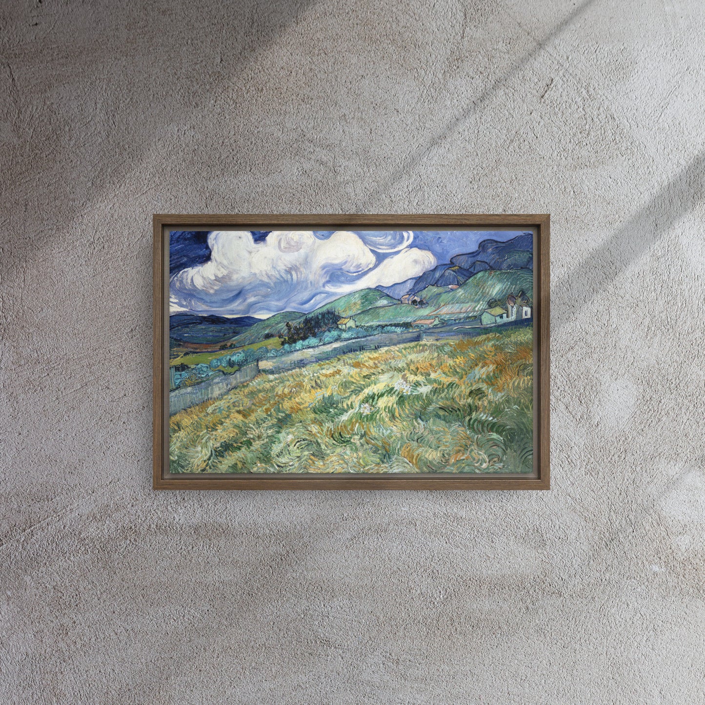 Van Gogh's 'Landscape from Saint-Rémy' on a 12"x18" brown framed canvas print on a textured gray wall.