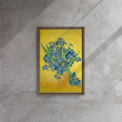 Van Gogh's 'Vase with Irises Against a Yellow Background' on a 12"x18" brown framed canvas print on a textured gray wall.