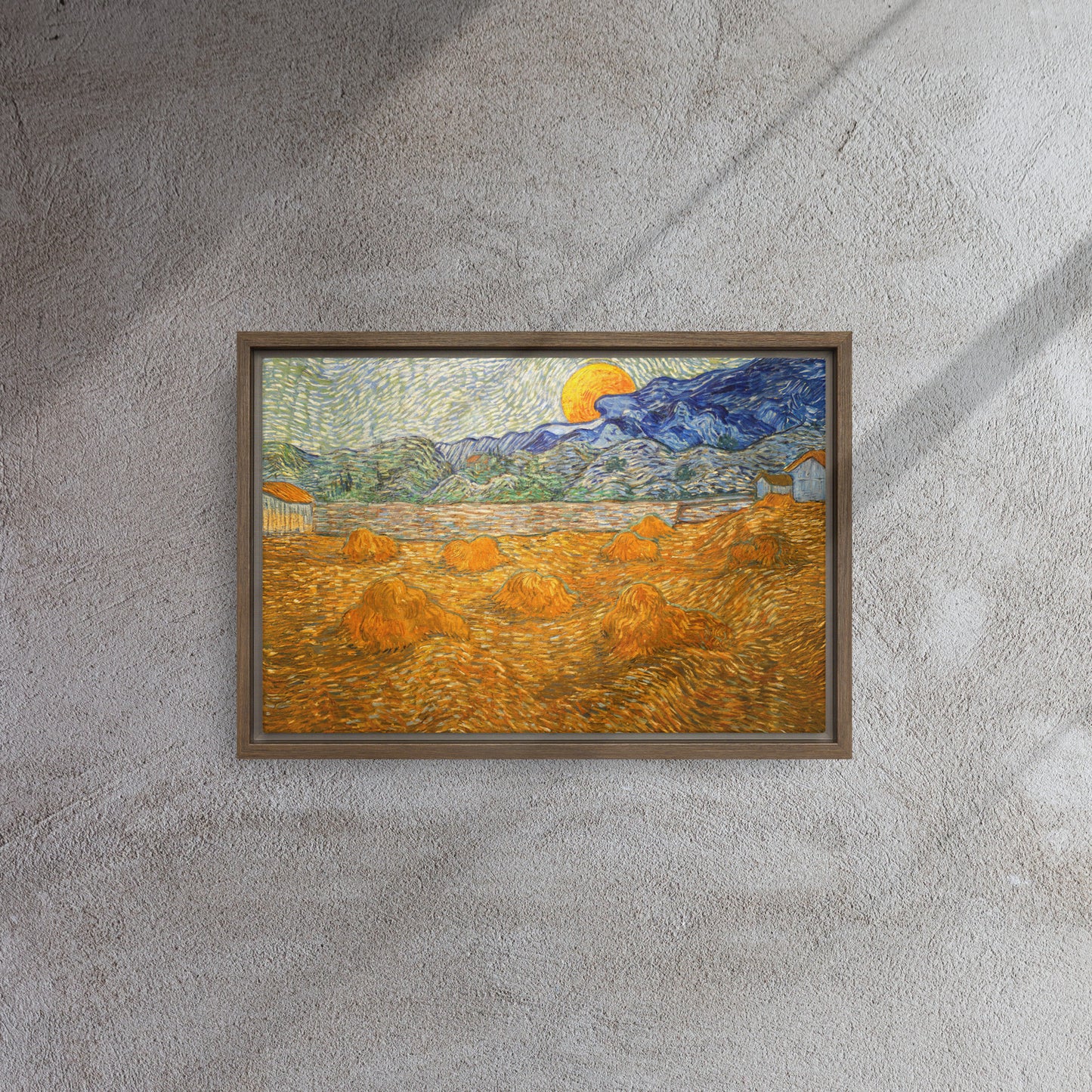 Van Gogh's 'Landscape with Wheat Sheaves and Rising Moon' on a 12"x18" brown framed canvas print on a textured gray wall.