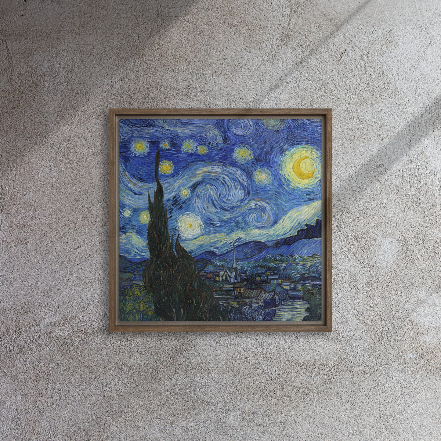 Van Gogh's 'Starry Night' on a 16"x16" brown framed canvas print on a textured gray wall.