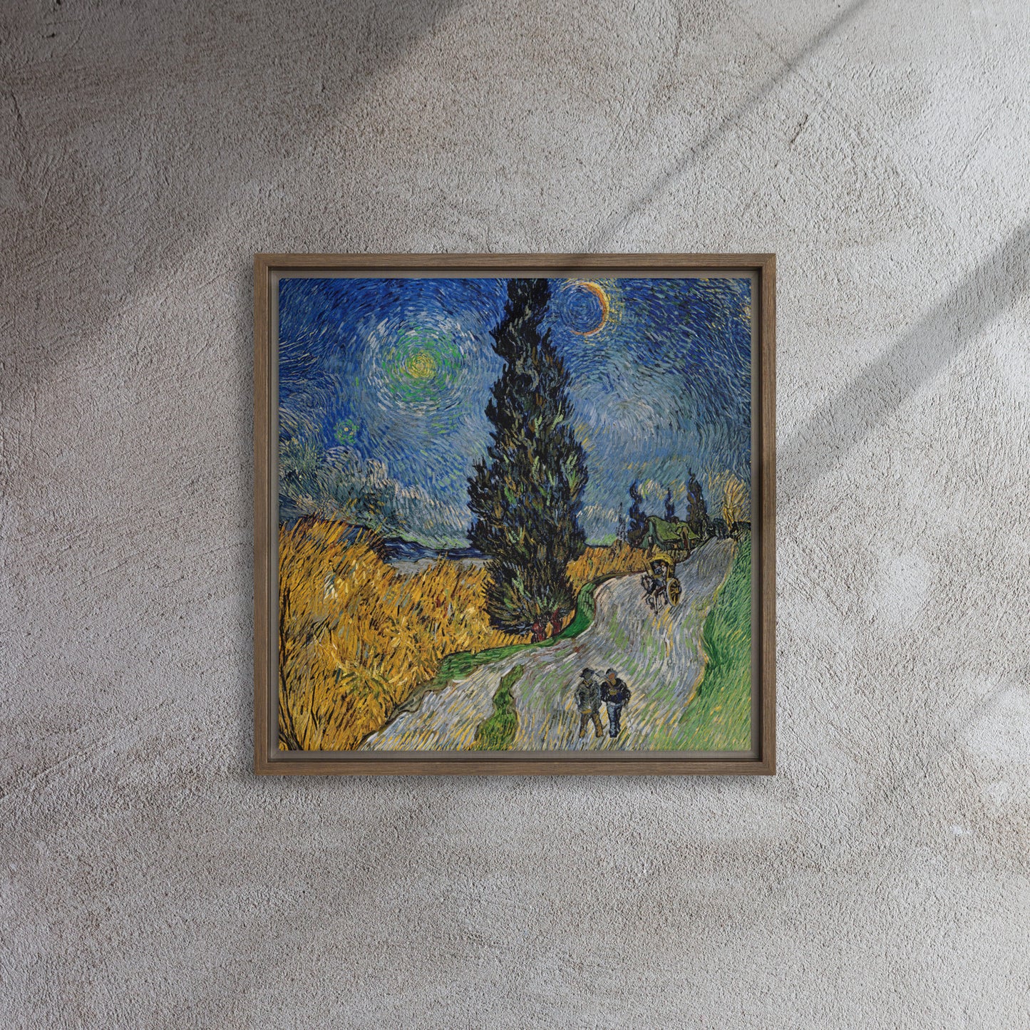 Van Gogh's 'Road with Cypress and Star' on a 16"x16" brown framed canvas print on a textured gray wall.