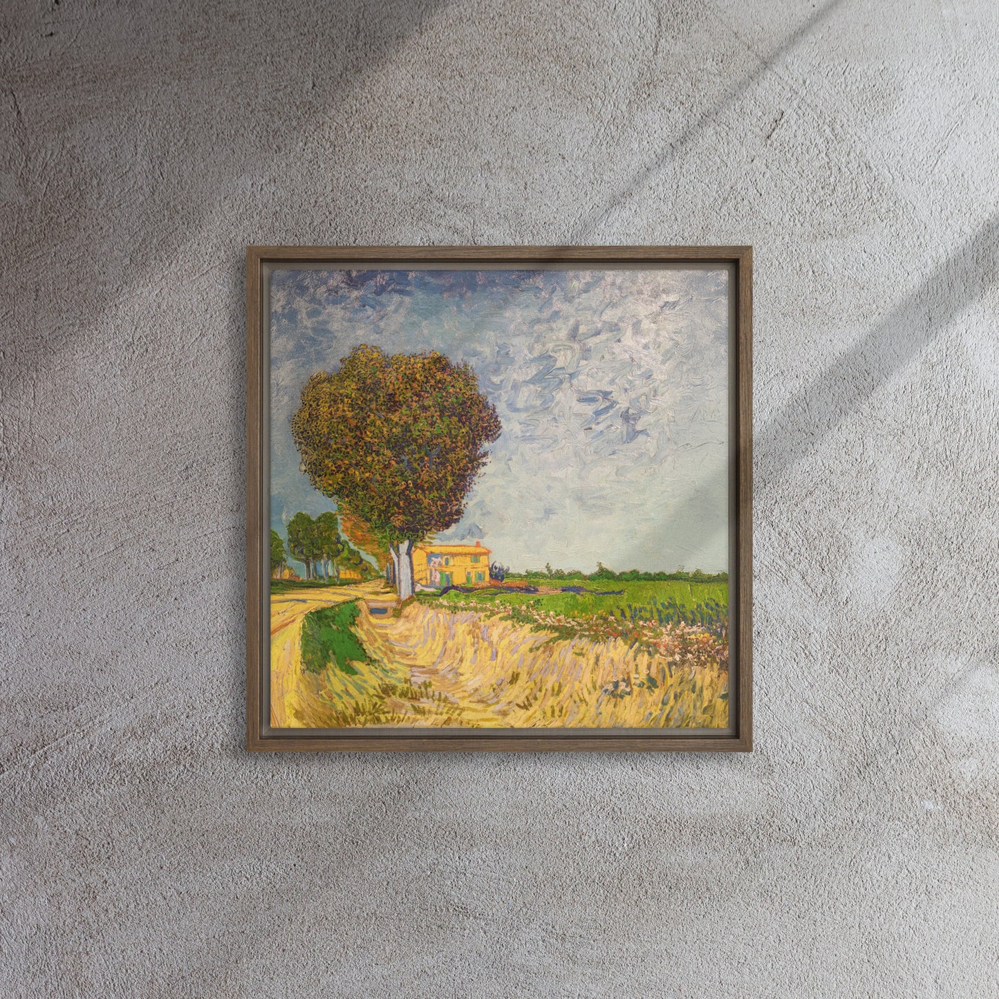 Van Gogh's 'A Lane near Arles' on a 16"x16" brown framed canvas print on a textured gray wall.