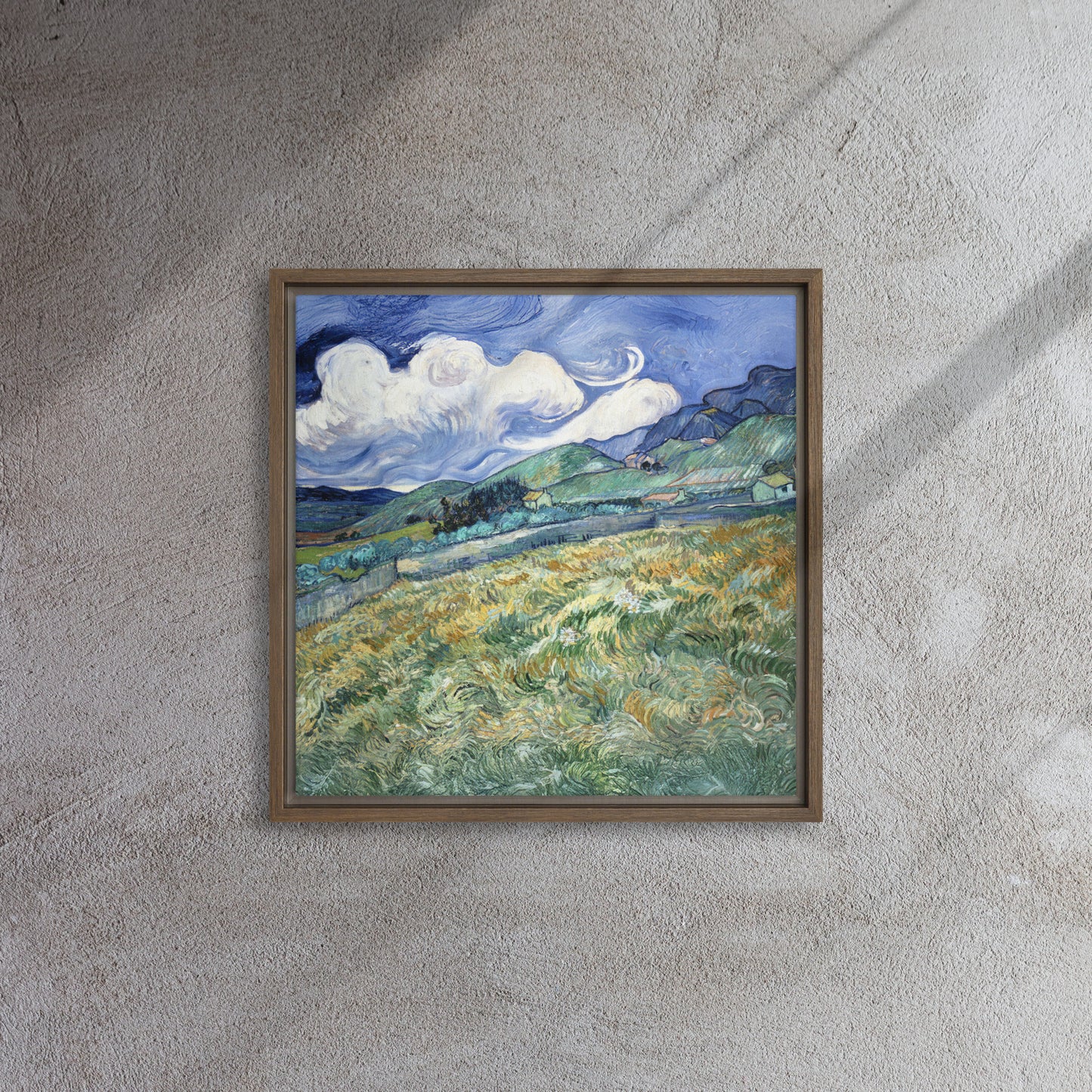 Van Gogh's 'Landscape from Saint-Rémy' on a 16"x16" brown framed canvas print on a textured gray wall.