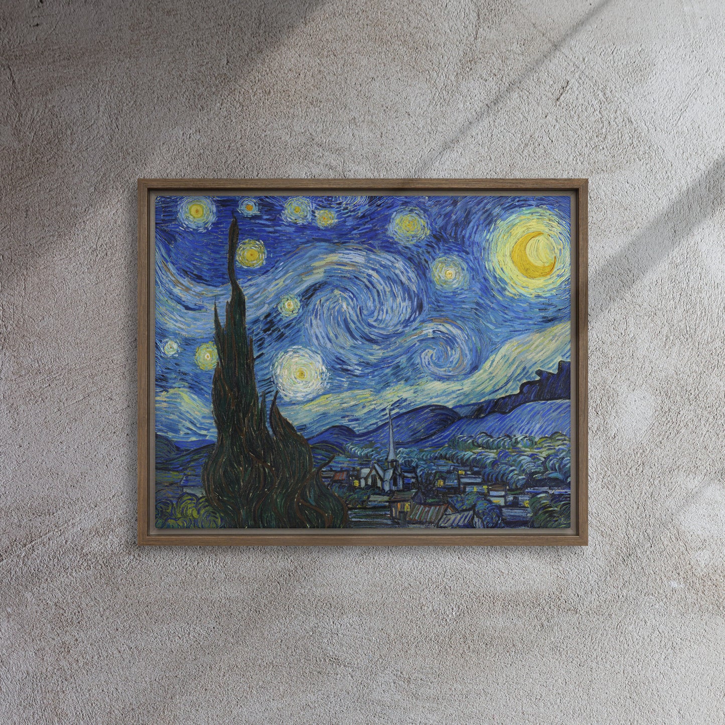 Van Gogh's 'Starry Night' on a 16"x20" brown framed canvas print on a textured gray wall.