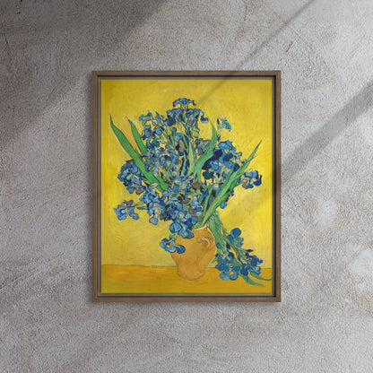Van Gogh's 'Vase with Irises Against a Yellow Background' on a 16"x20" brown framed canvas print on a textured gray wall.