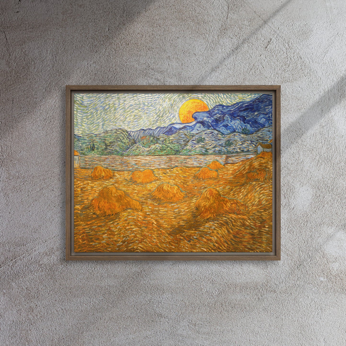 Van Gogh's 'Landscape with Wheat Sheaves and Rising Moon' on a 16"x20" brown framed canvas print on a textured gray wall.