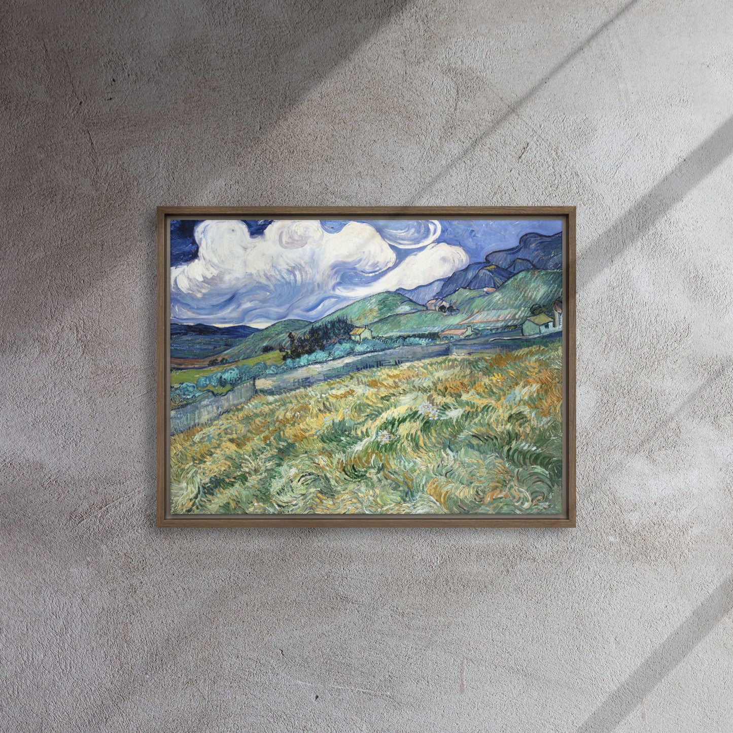 Van Gogh's 'Landscape from Saint-Rémy' on a 18"x24" brown framed canvas print on a textured gray wall.