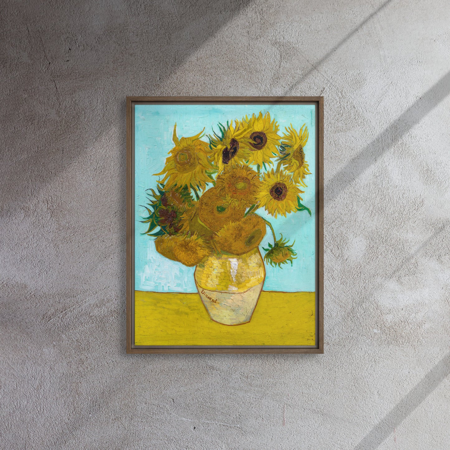 Van Gogh's 'Vase with Twelve Sunflowers' on a 18"x24" brown framed canvas print on a textured gray wall.
