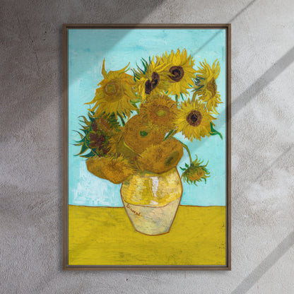 Van Gogh's 'Vase with Twelve Sunflowers' on a 24"x36" brown framed canvas print on a textured gray wall.