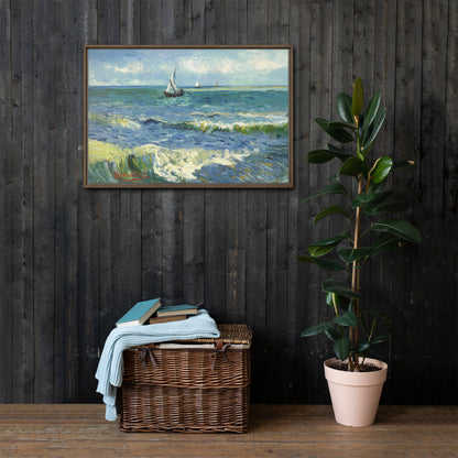 Van Gogh's 'The Sea at Les Saintes-Maries-de-la-Mer' on a 24"x36" brown framed canvas print on a dark wooden wall with a wicker bin and plant below.