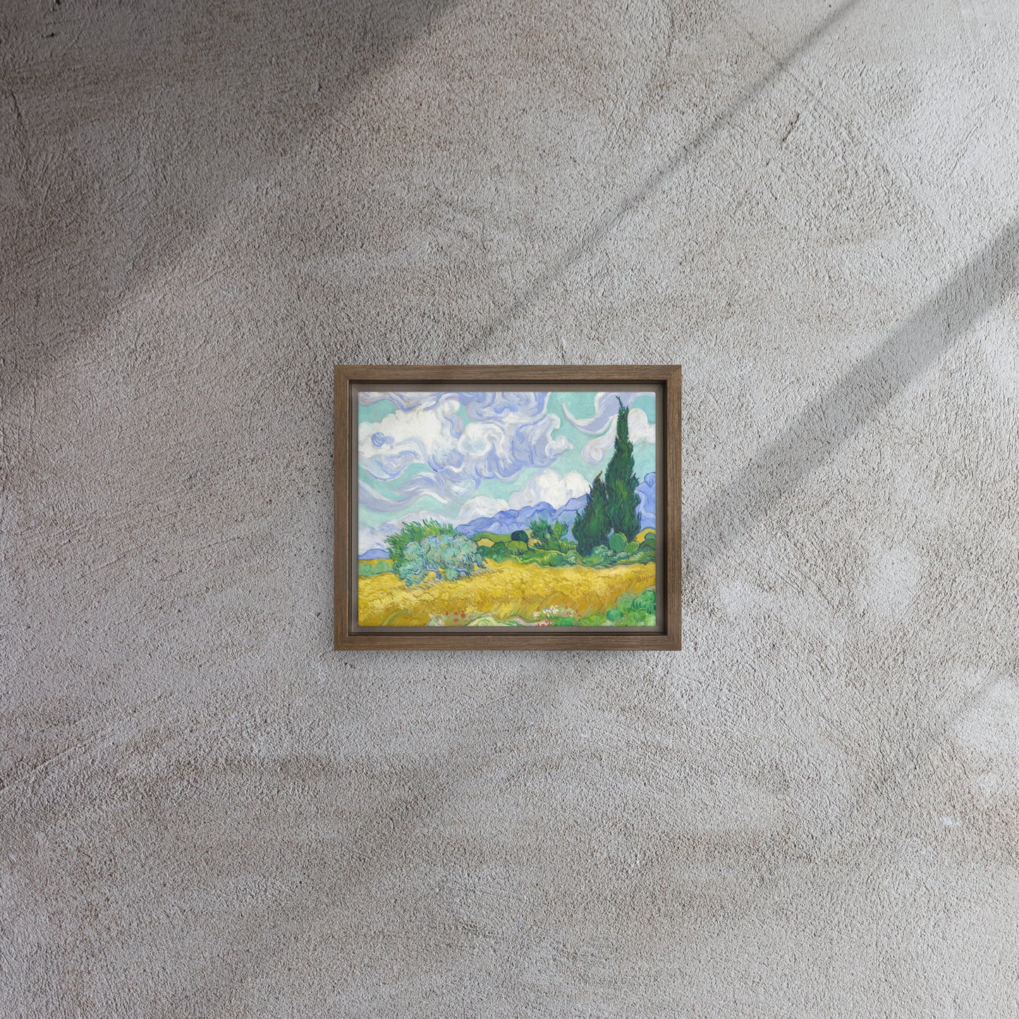 Van Gogh's 'Wheat Field with Cypresses' on a 8"x10" brown framed canvas print on a textured gray wall.