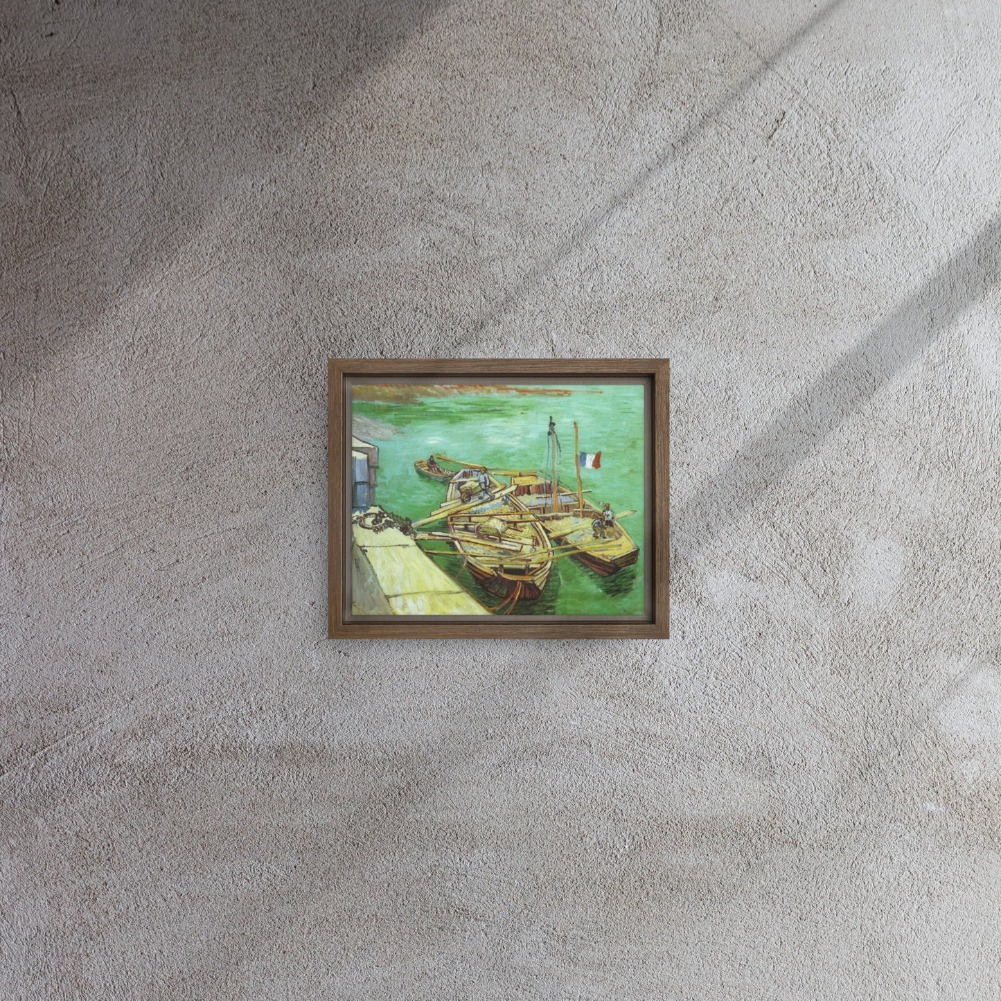 Van Gogh's 'Quay with Men Unloading Sand Barges' on a 8"x10" brown framed canvas print on a textured gray wall.