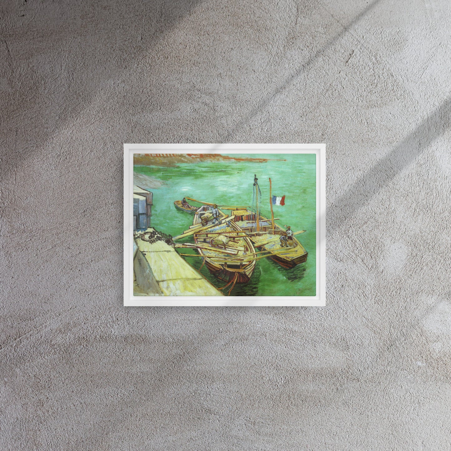 Van Gogh's 'Quay with Men Unloading Sand Barges' on a 11"x14" white framed canvas print on a textured gray wall.