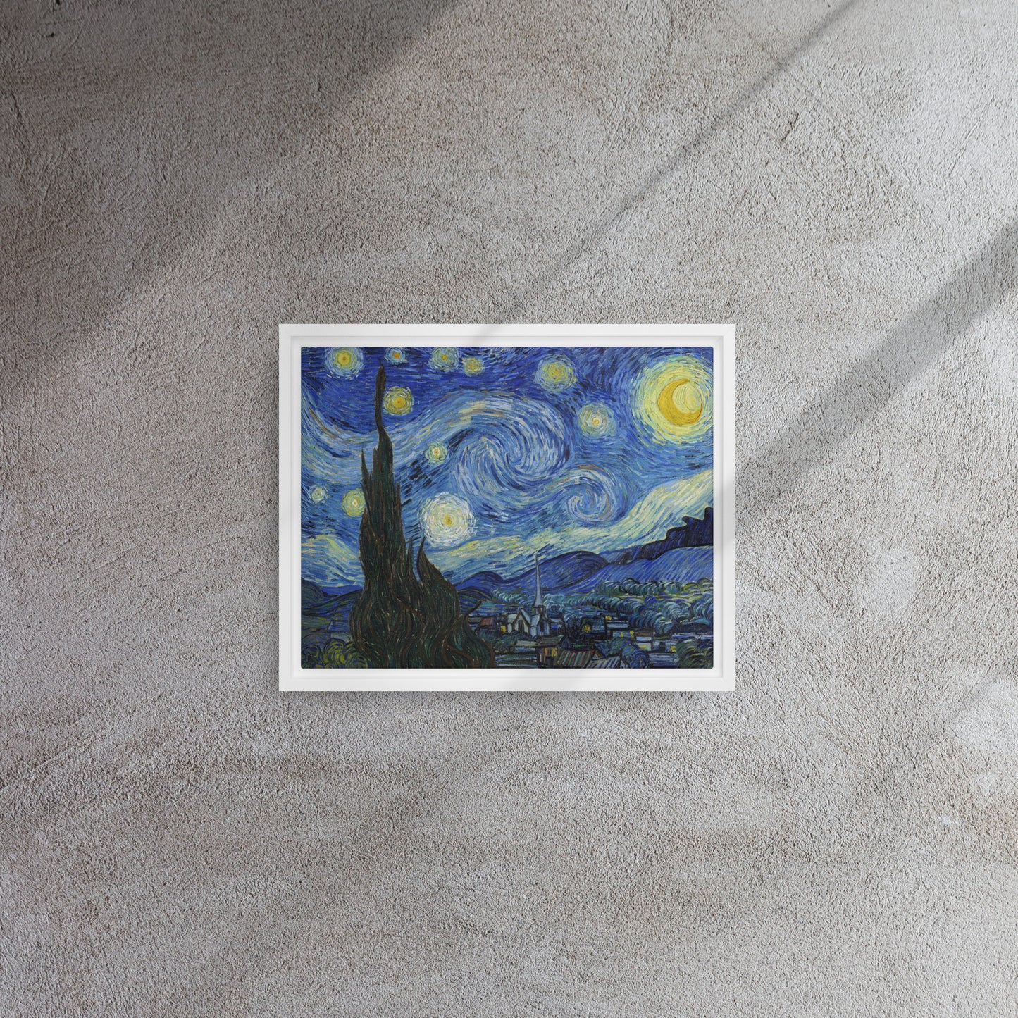 Van Gogh's 'Starry Night' on a 11"x14" white framed canvas print on a textured gray wall.