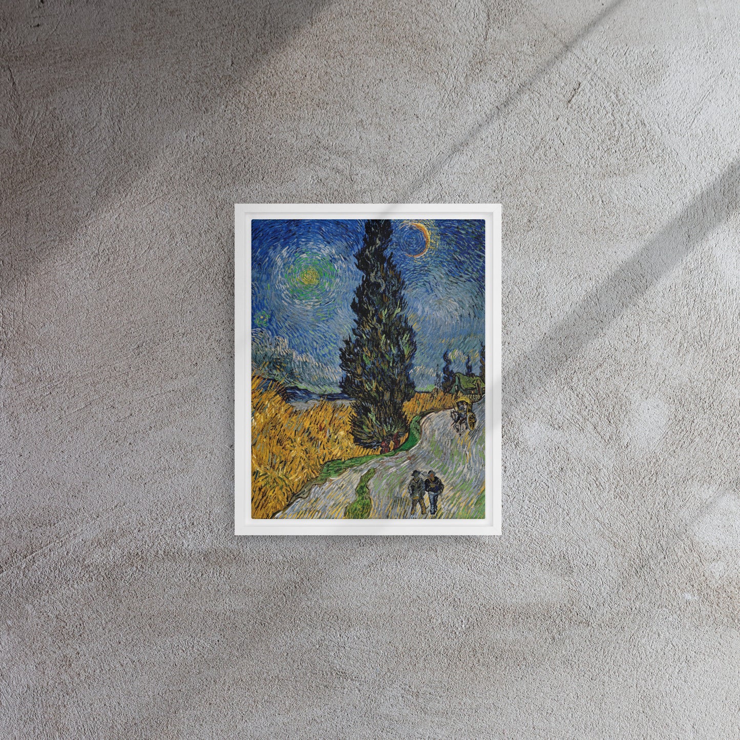 Van Gogh's 'Road with Cypress and Star' on a 11"x14" white framed canvas print on a textured gray wall.