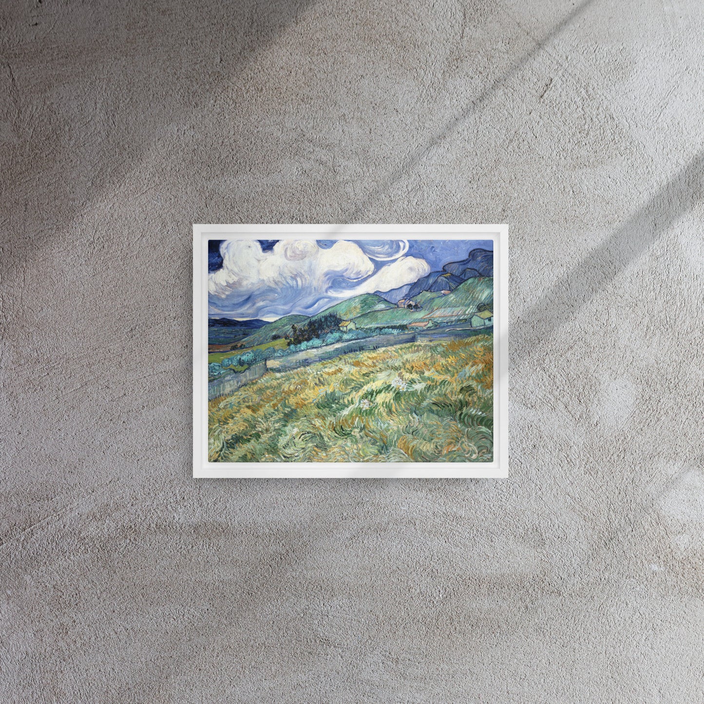 Van Gogh's 'Landscape from Saint-Rémy' on a 11"x14" white framed canvas print on a textured gray wall.