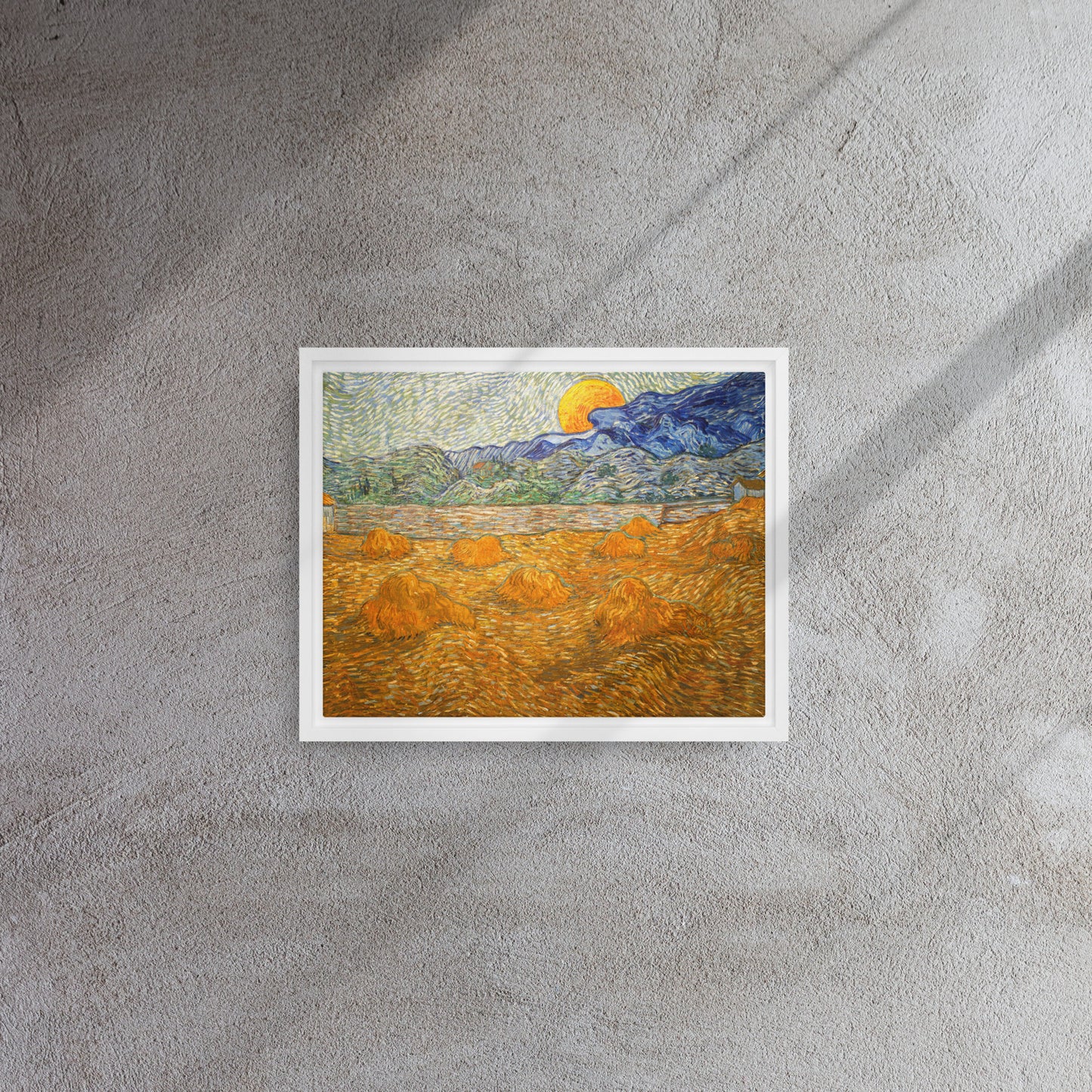 Van Gogh's 'Landscape with Wheat Sheaves and Rising Moon' on a 11"x14" white framed canvas print on a textured gray wall.