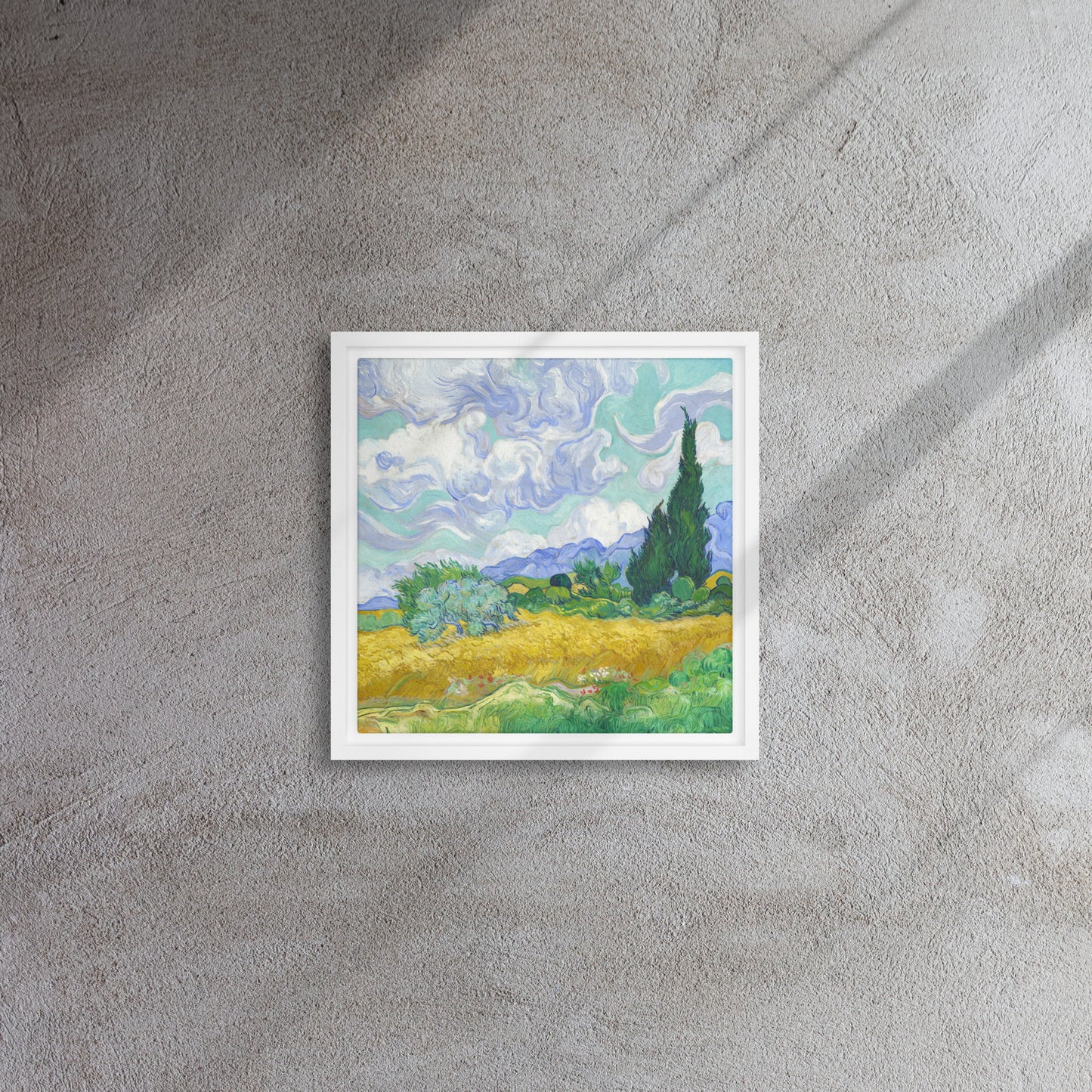 Van Gogh's 'Wheat Field with Cypresses' on a 12"x12" white framed canvas print on a textured gray wall.