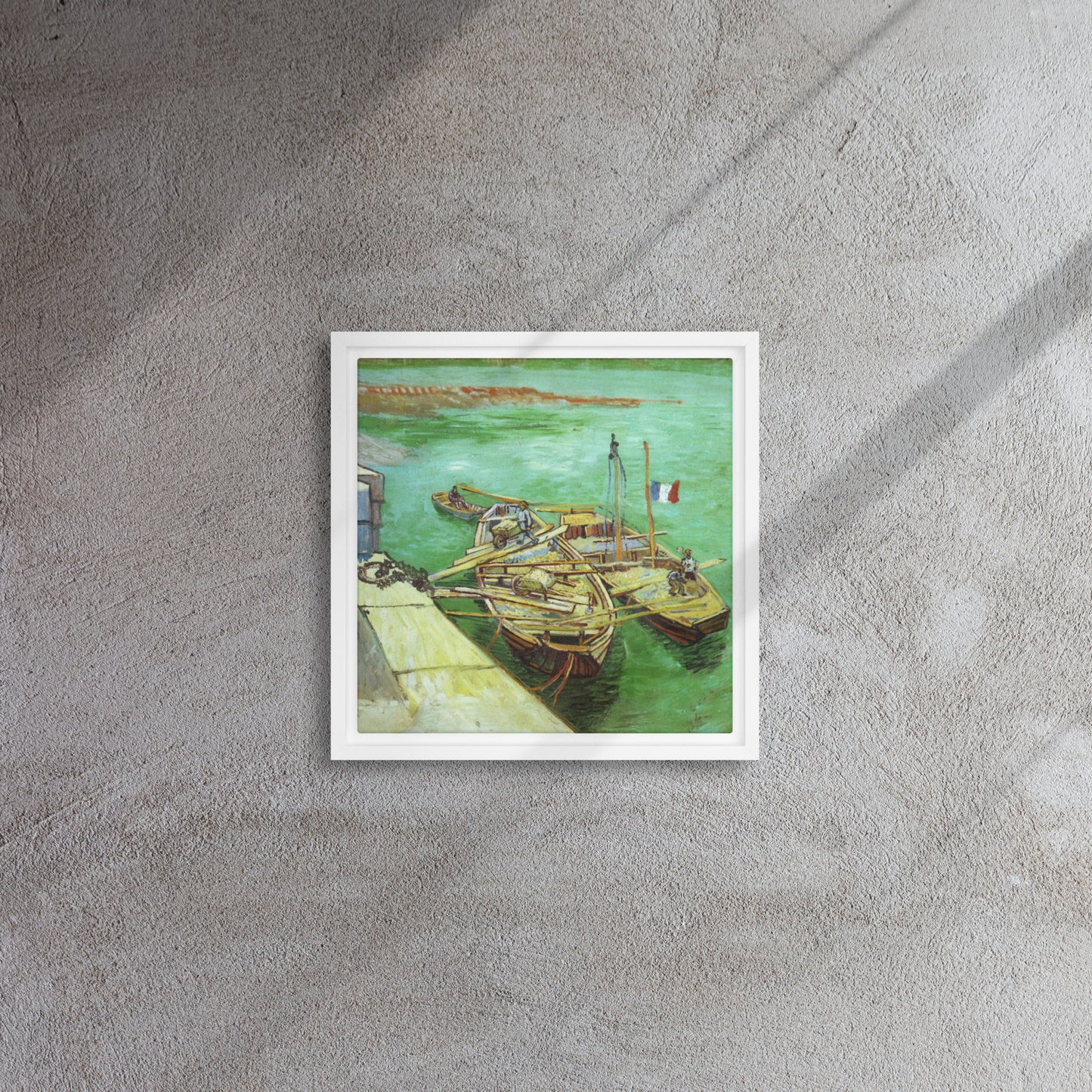 Van Gogh's 'Quay with Men Unloading Sand Barges' on a 12"x12" white framed canvas print on a textured gray wall.