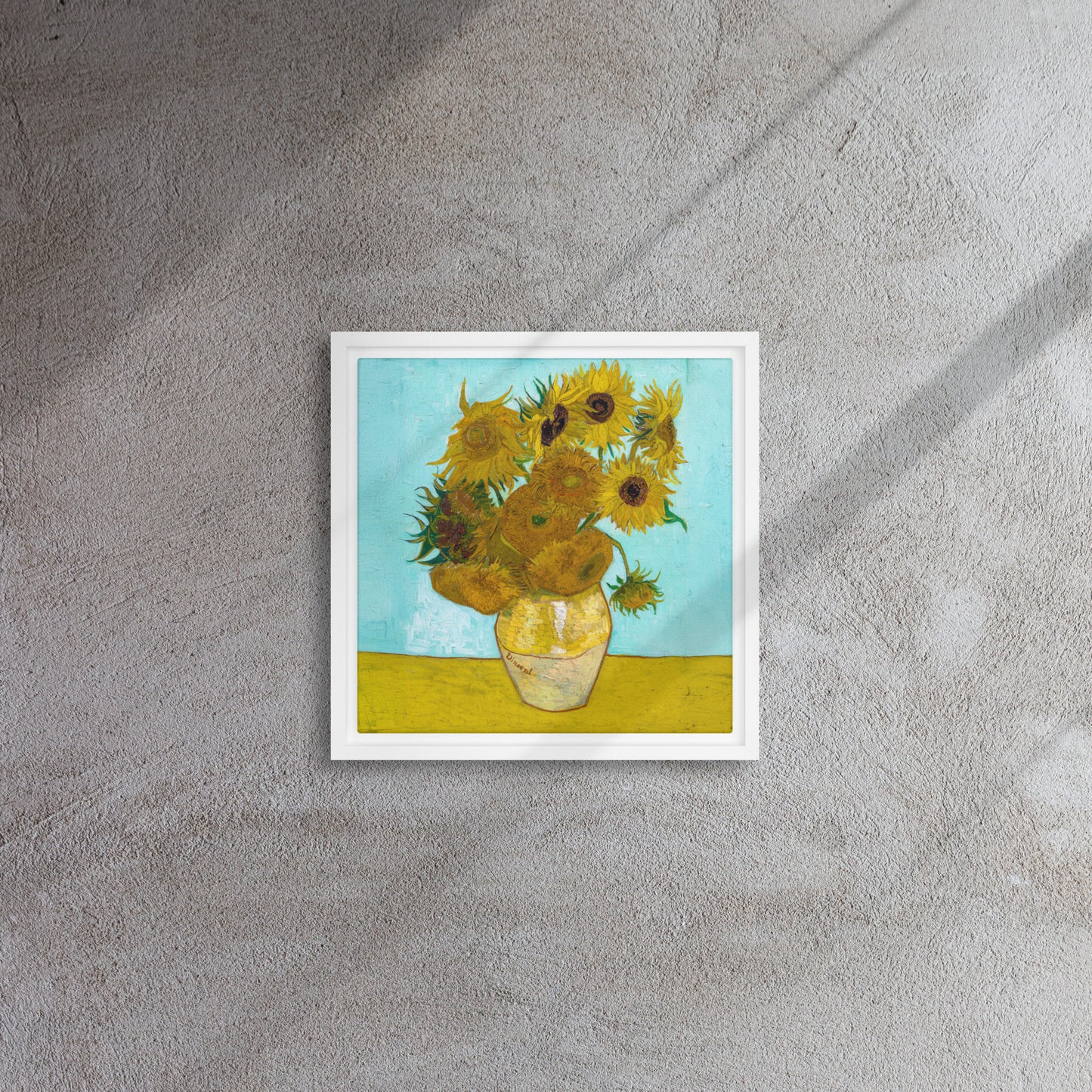 Van Gogh's 'Vase with Twelve Sunflowers' on a 12"x12" white framed canvas print on a textured wall.