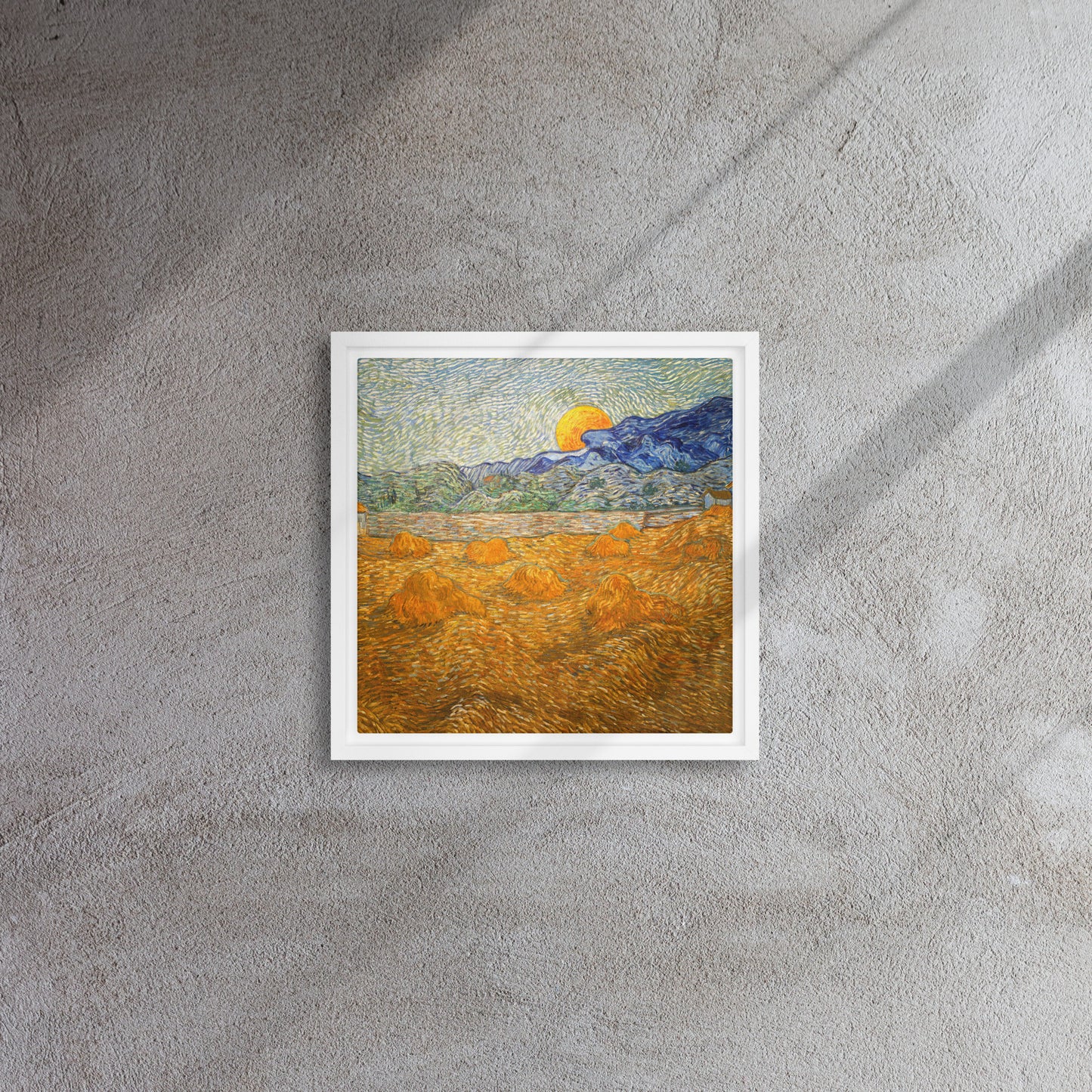 Van Gogh's 'Landscape with Wheat Sheaves and Rising Moon' on a 12"x12" white framed canvas print on a textured gray wall.