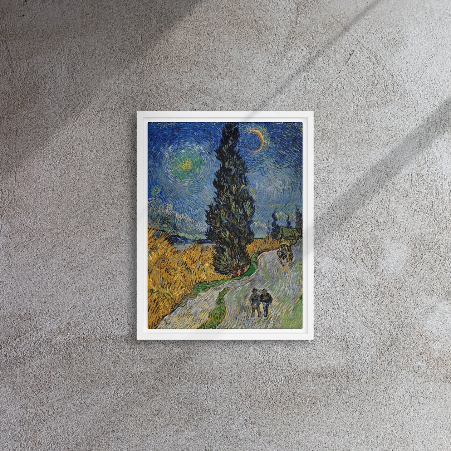 Van Gogh's 'Road with Cypress and Star' on a 12"x16" white framed canvas print on a textured gray wall.